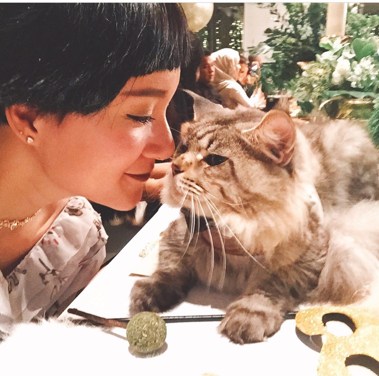 Woman bonding closely with her Maine Coon cat