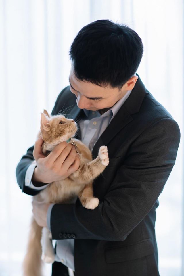A Thai man lovingly holding his Maine Coon cat – heartfelt story of bonding after adoption from Tigercooncat